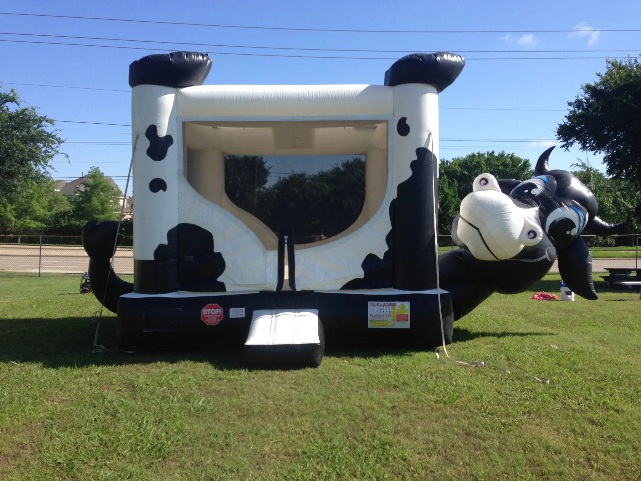 Jumper Bee crew setting up a cow belly bouncer at a Howe TX ranch event