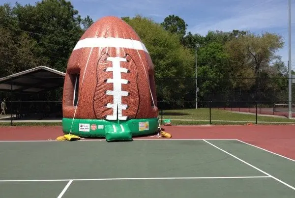 Inflatable football sports game rental at a DFW school event