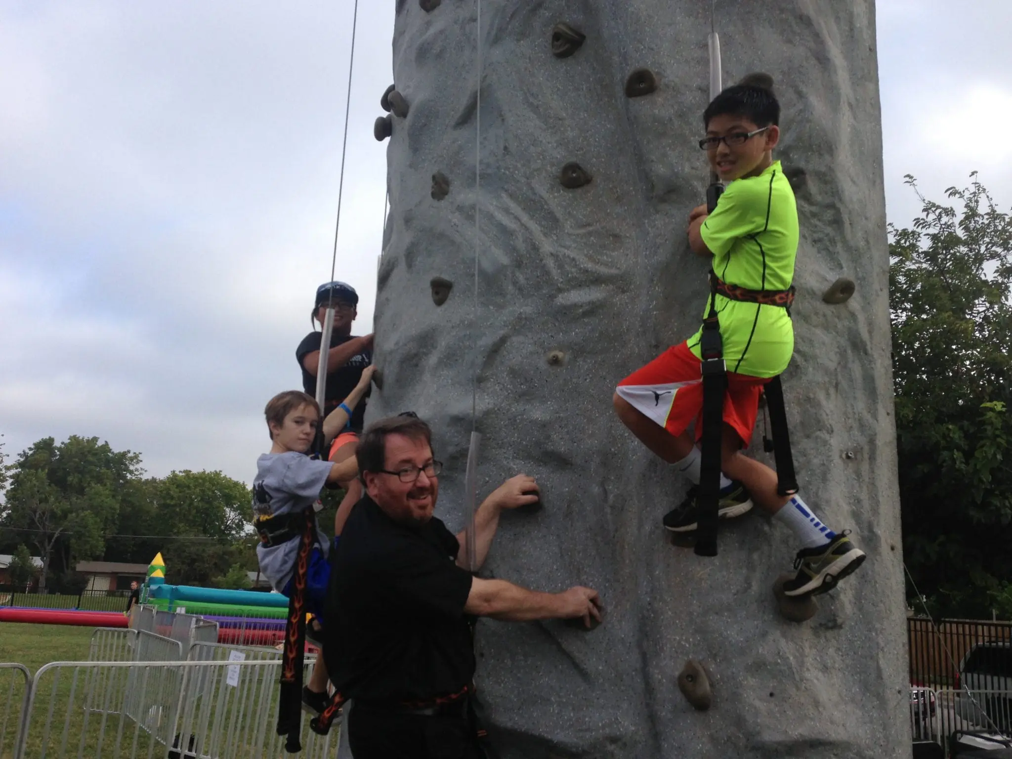 Branded carnival midway staged for a Dallas Fort Worth corporate Family Day picnic at a Legacy West campus green