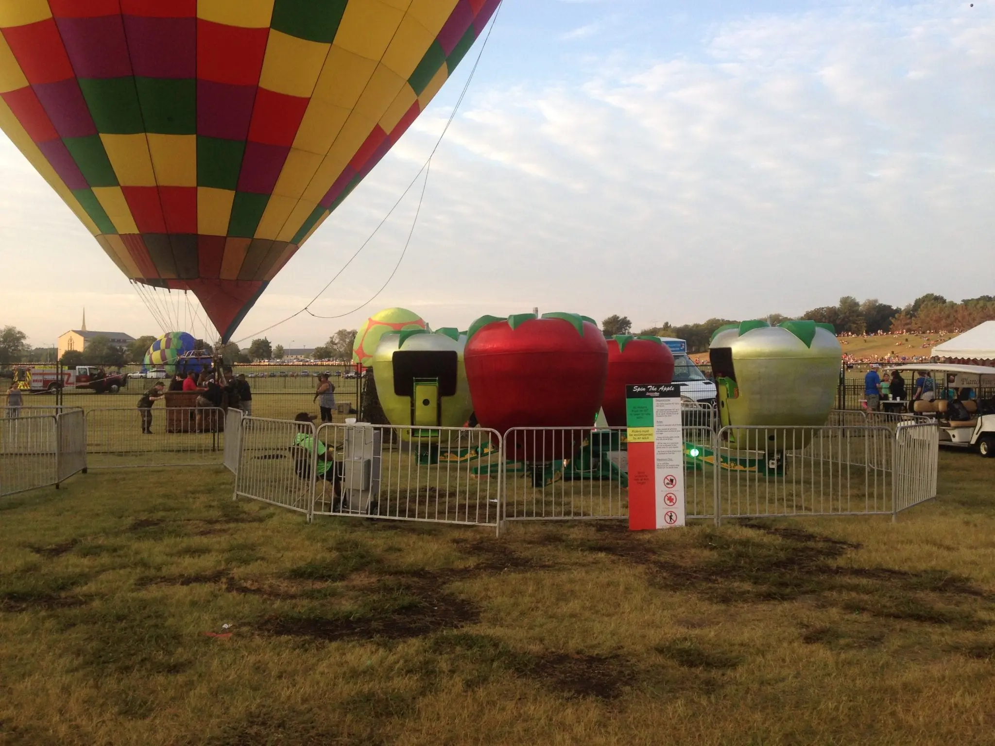 Spin the Apple carnival ride rental with riders in apple-shaped cars at a Dallas Fort Worth fall festival