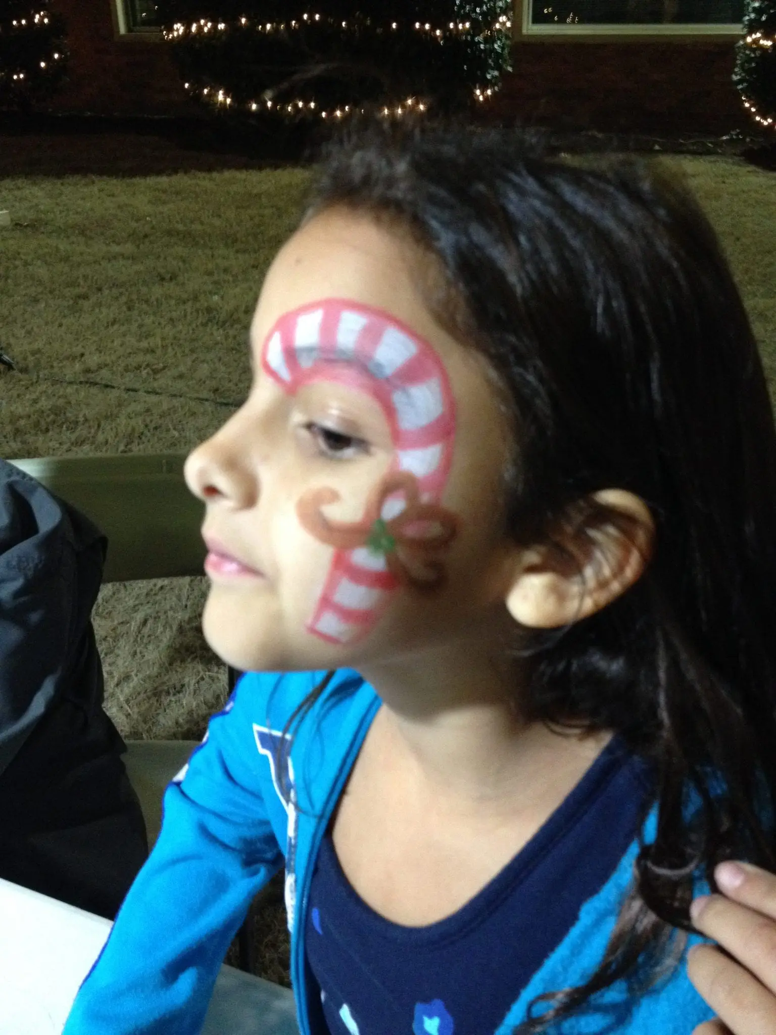 Detail of a finished DFW face paint design on a child at a Jumper Bee event