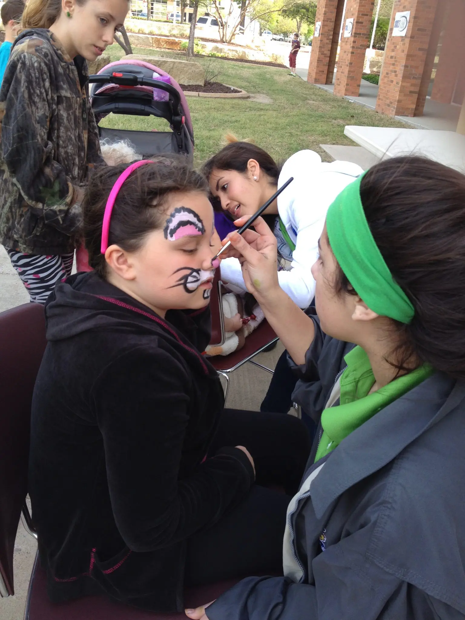 Jumper Bee face painter at work on a young guest at a DFW event